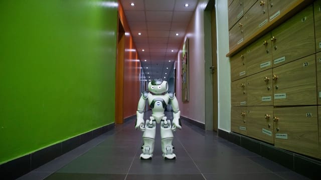 A humanoid robot stands in a vibrant, modern hallway in Lagos, Nigeria.