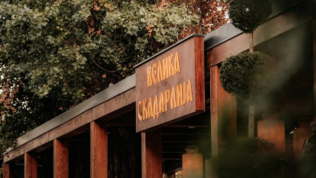 Moody exterior of a traditional restaurant in autumn with colorful foliage.