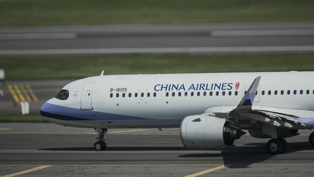 Side view of a China Airlines Airbus taxiing on the runway at Taoyuan Airport, Taiwan.
