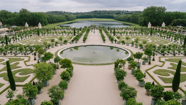 Explore the intricate gardens of Versailles, showcasing nature's beauty and elaborate design in a vast outdoor setting.
