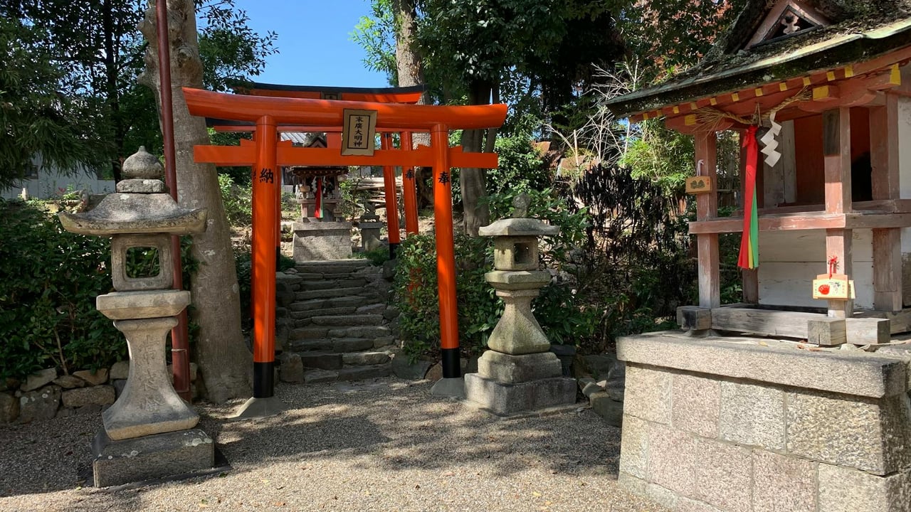 Traditional Japanese shrine with red Torii gate and stone lanterns in Nara Park, Japan.