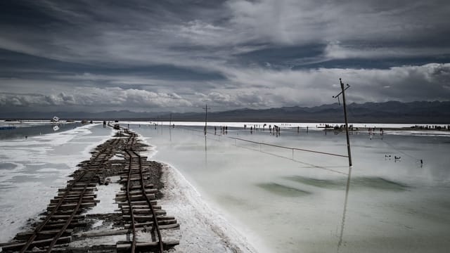 A captivating scene at Chaka Salt Lake in China featuring a railway and stunning sky reflection.