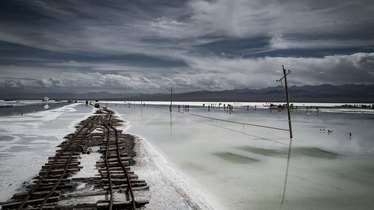A captivating scene at Chaka Salt Lake in China featuring a railway and stunning sky reflection.