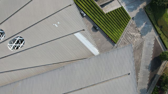 Aerial view of geometric building roofs and greenery in Wuxi, Jiangsu, China.