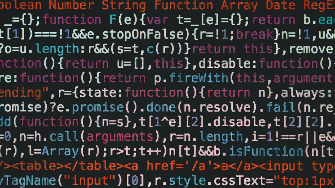 Close-up of colorful coding text on a dark computer screen, representing software development.