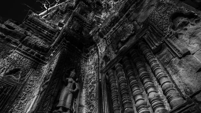 A striking black and white perspective of ancient Angkor Wat temple carvings in Cambodia.
