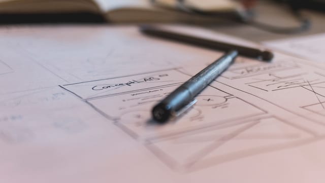 A sketch with notes and a pen on paper. Ideal for planning or design concepts.