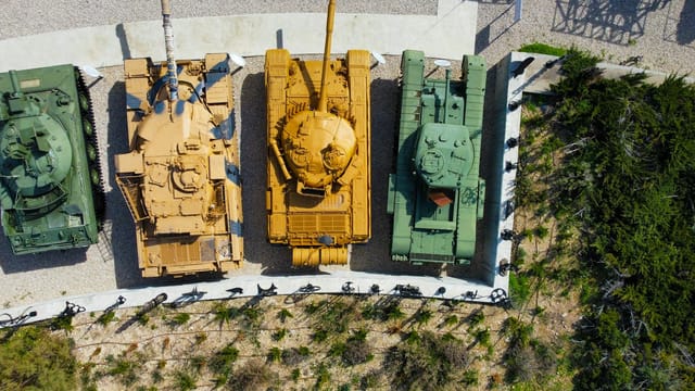 Drone shot of military tanks displayed outdoors at a museum in Jerusalem, Israel.