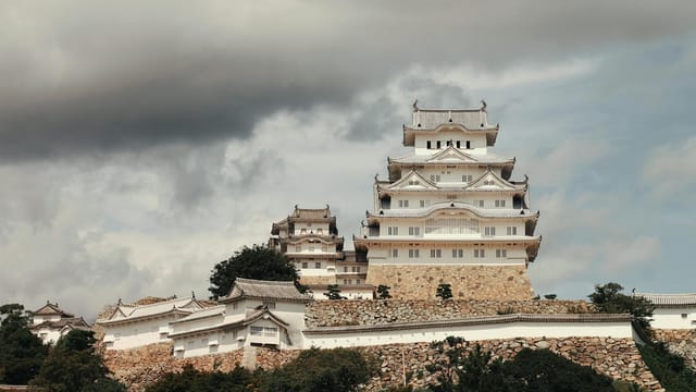 Beautiful view of Himeji Castle in Japan, showcasing classic architecture under clouded skies.