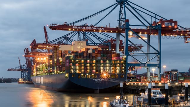 Illustrative image: Container ships moored at Terminal Burchardkai in Hamburg, Germany during evening hours.