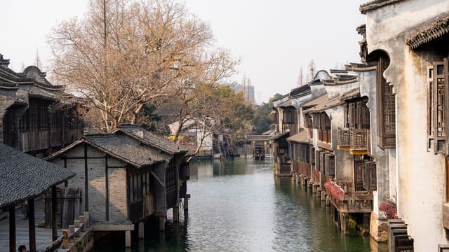 A serene view of traditional water town architecture in China during the day.