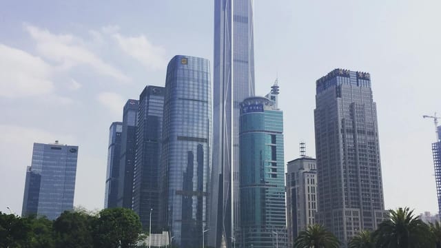 Modern skyscrapers in Shenzhen's downtown showcasing futuristic architecture under clear skies.