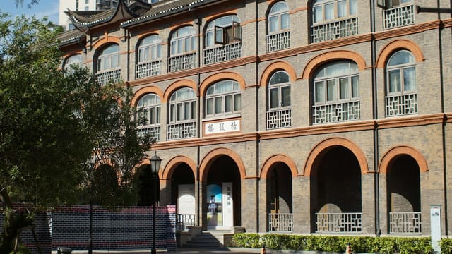 A historic building in Shanghai with an arched brick facade, typical of traditional Chinese architecture.