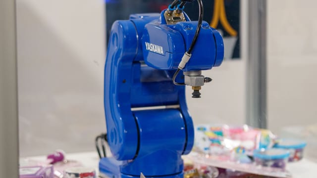Illustrative image: A blue Yaskawa industrial robot arm on display, showcasing advanced technology and robotics.