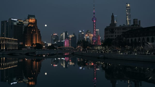 Stunning Shanghai cityscape featuring the illuminated Oriental Pearl Tower at night.