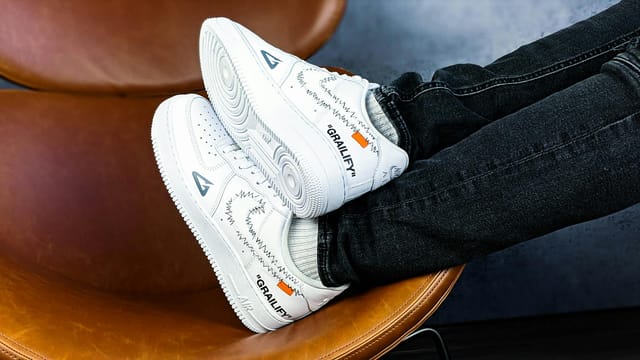 Close-up of stylish Nike sneakers with a unique design, resting on a modern chair for a trendy look.