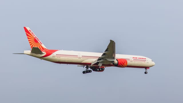 Air India Boeing 777 captured in clear sky during flight approach. Perfect aviation stock image.