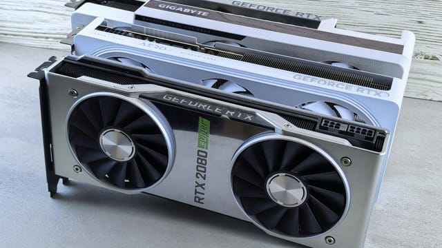 Three NVIDIA GeForce RTX graphics cards stacked on a surface, showcasing their sleek design and branding details.