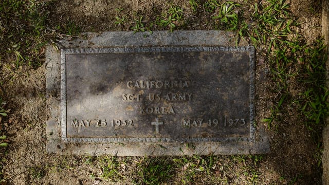 Close-up of a US Army sergeant's gravestone from the Korean War era in California.