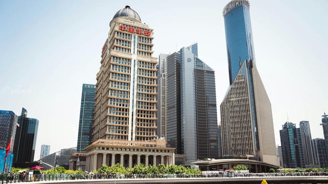 Exterior of contemporary office skyscrapers located in downtown of Shanghai on clear summer day