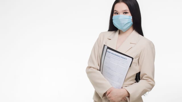 Illustrative image: Professional woman wearing face mask holding insurance document, demonstrating safety and business.