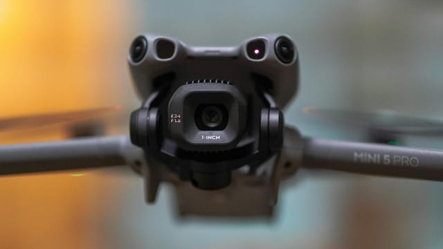 Detailed close-up of drone camera lens and propellers, featuring advanced technology.