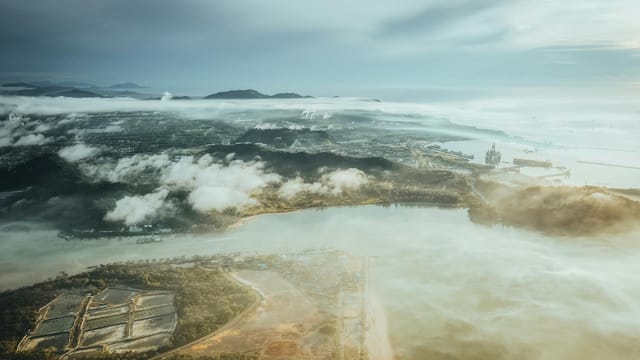 A stunning aerial view of Chukai, Terengganu's coastline with clouds and sea.