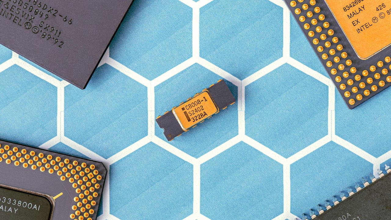 Close-up of various microprocessor chips on a blue hexagonal patterned surface, highlighting electronic technology.