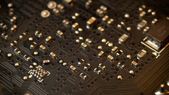 Detailed view of a circuit board showing various electronic components and traces.