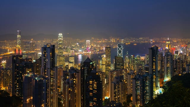 Breathtaking nighttime view of Hong Kong's vibrant skyline shining with city lights.