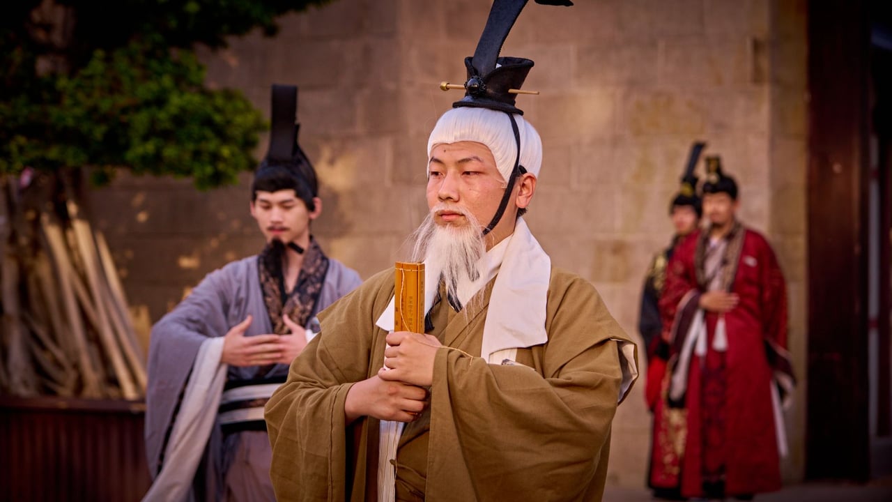 Men in traditional costumes perform a historical ceremony outdoors.
