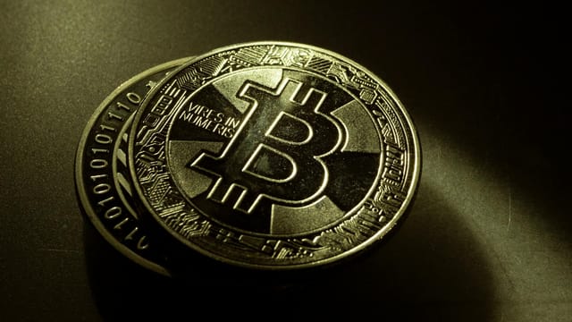 Detailed shot of a Bitcoin coin with a digital texture highlighting its cryptocurrency design.