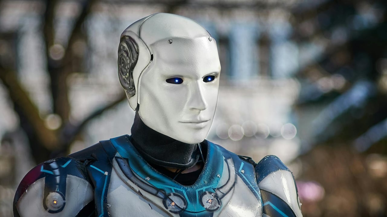 Close-up of a futuristic humanoid robot with metallic armor and blue LED eyes.