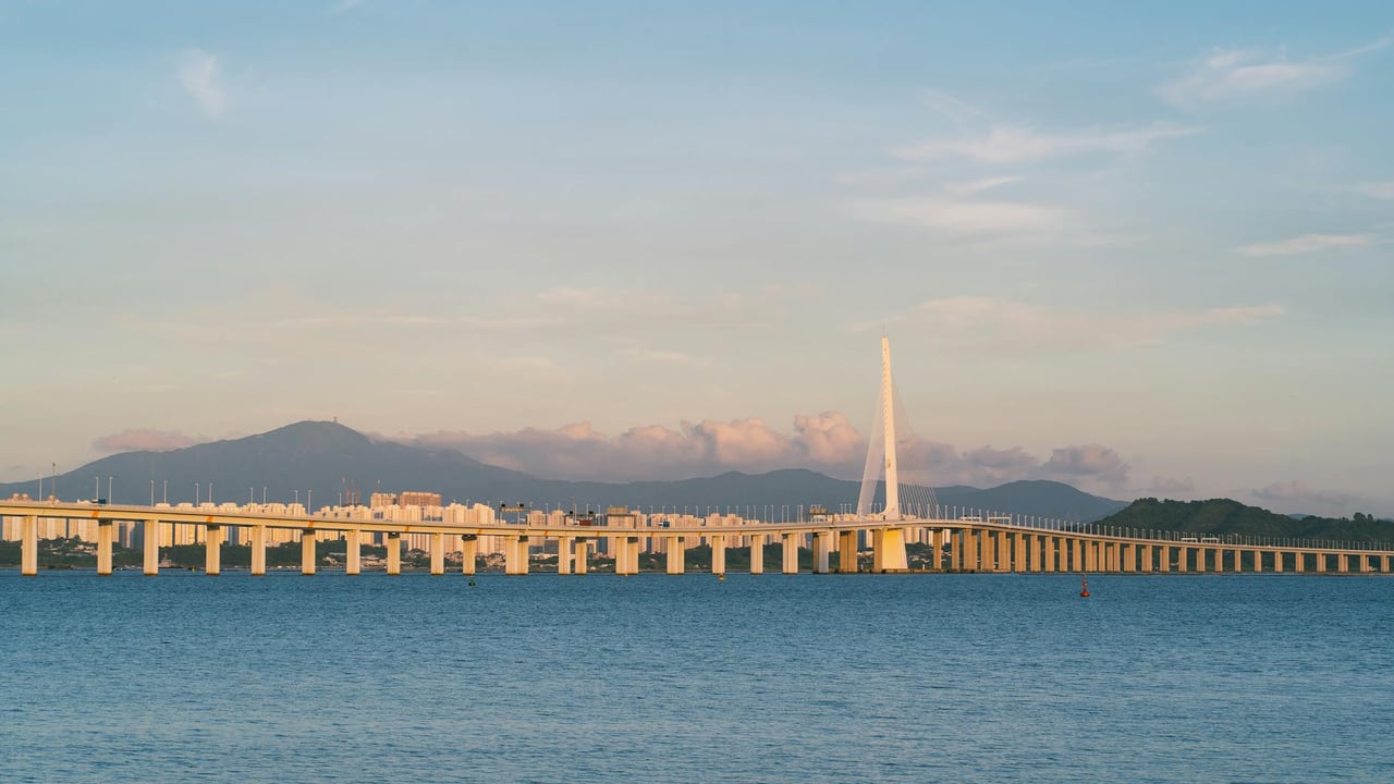 Panoramic view of the Shenzhen Bay Bridge connecting Hong Kong and Shenzhen at sunset.