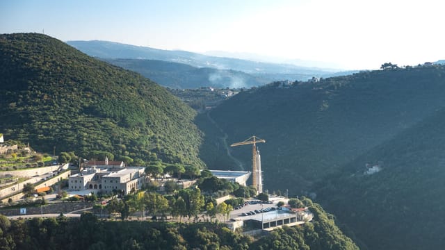 A stunning aerial view of Ghouma village nestled in lush green hills of Lebanon.