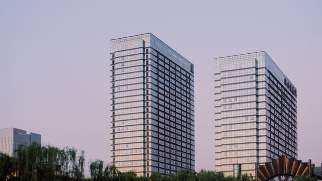 Elegant glass skyscrapers reflecting the evening sky in a modern cityscape.