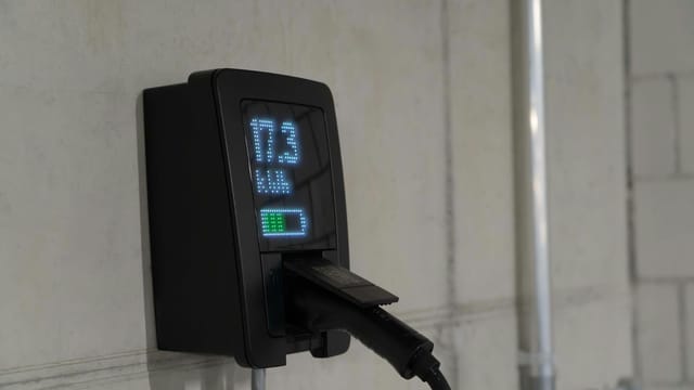 Detailed view of an electric vehicle charging station indoors, showcasing charging technology.