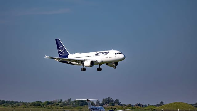 Lufthansa aircraft approaching for landing at Sylt Airport on a clear day.