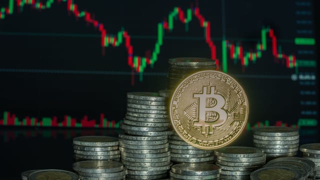 Bitcoin coins stacked with a financial graph in the background symbolize digital currency growth.