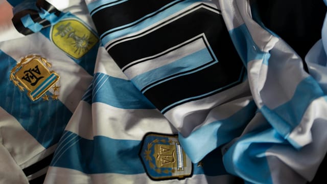 Close-up of Argentina soccer jerseys featuring national emblems and iconic designs.