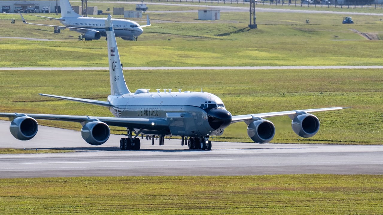 U.S. Air Force plane on runway ready for takeoff on a sunny day.