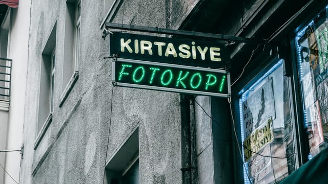 Neon signs in an Istanbul street, showcasing a photocopy shop signage.